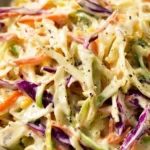 Bowl of fresh coleslaw with vibrant vegetables and creamy dressing