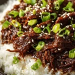 Delicious bowl of Slow Cooker Korean Beef served with rice and vegetables
