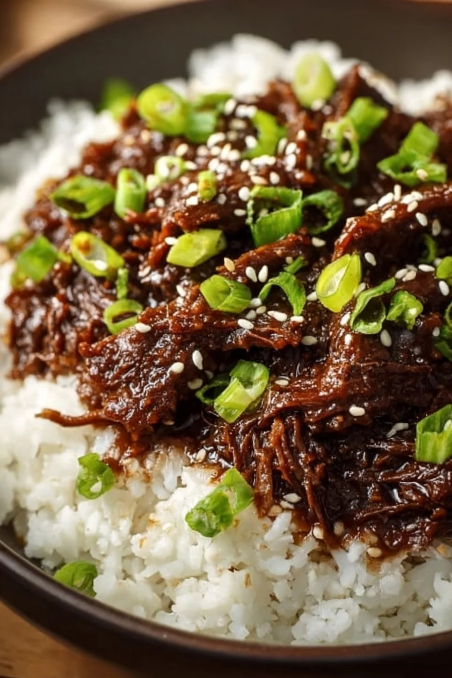 Delicious bowl of Slow Cooker Korean Beef served with rice and vegetables