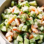 A variety of cucumber salad dishes including Caprese and California roll.