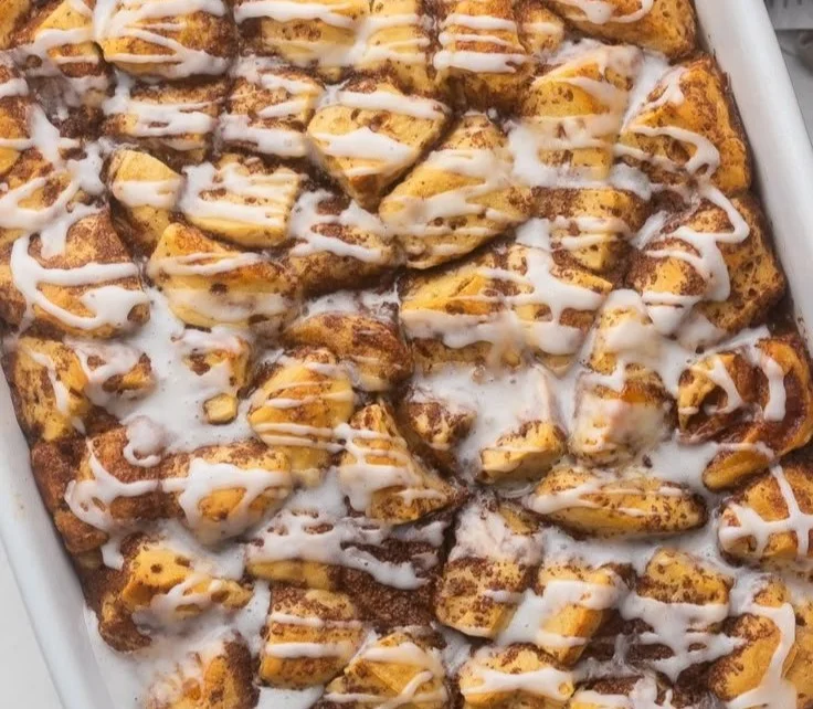 Delicious easy cinnamon roll casserole topped with icing and served warm