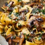 Delicious Garlic Mushroom Pasta garnished with herbs and cheese