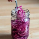 Lacto-fermented red onions in a jar, a healthy probiotic condiment