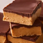 No-Bake Peanut Butter Buckeye Bars topped with chocolate in a dish