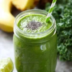 Delicious Pineapple Banana Kale Smoothie in a clear glass with fresh ingredients