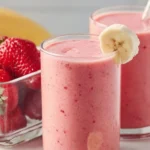 Delicious strawberry banana smoothie in a glass with fresh fruit slices