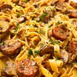 Delicious Tagliatelle Stroganoff with sausages and chestnut mushrooms served in a bowl.