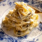 Plate of Tagliatelle with Truffle Sauce garnished with herbs