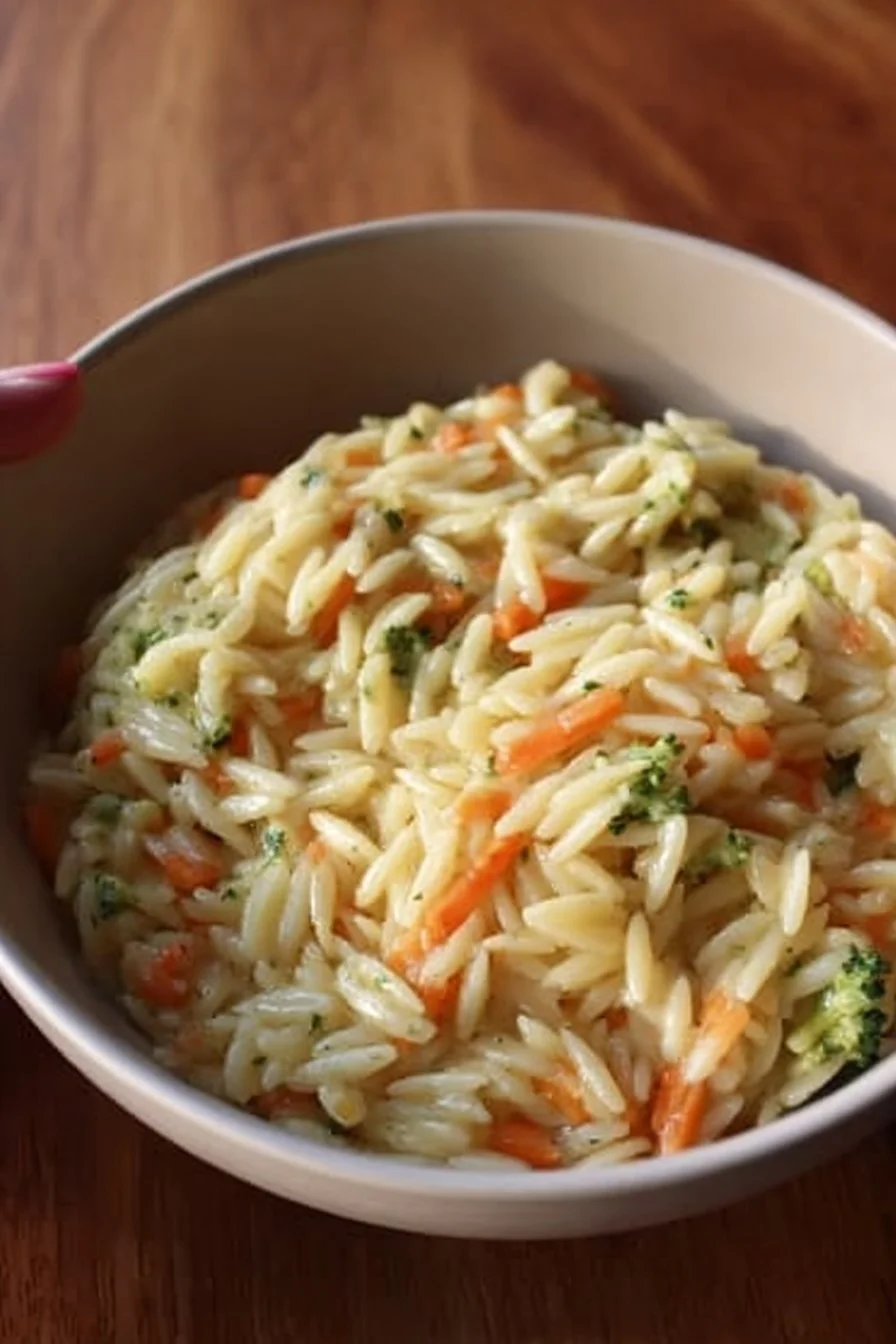 Colorful veggie orzo dish with fresh vegetables and herbs