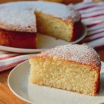 Italian Lemon Ricotta Cake topped with lemon zest and powdered sugar